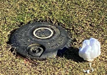 Foam spray applied marking agent on golf course grass dirt soil turf.