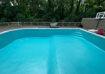 Chlorinated rubber coating to paint swimming pool concrete masonary surfaces.