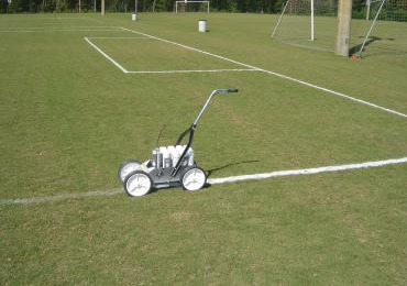 Soccer Field white lines sprayed aerosol can machine.