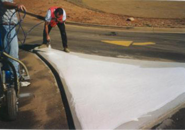 Spray application cold applied liquid thermoplastic traffic island painting.