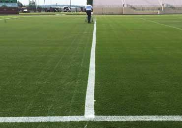 Bright durable white line field paint thinned with water.
