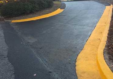 Yellow concrete curb paint black asphalt crack filler sealer.