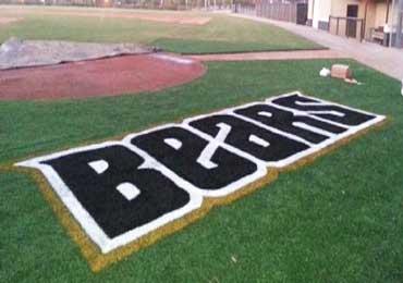 Finished permanent logo on synthetic turf with aerosol paint colors.