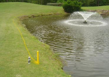 Durable bright paint for marking golf course water hazard.