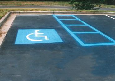 Handicap spot line sign legend bright durable aerosol blue paint.