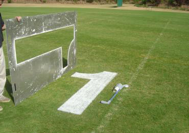 Paint for football field yardage numbers.
