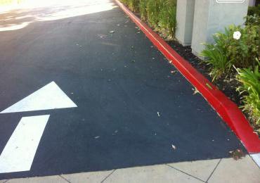 Bright red durable parking lot curb red paint white traffic arrow lane line marking paint.