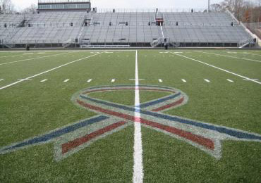 Ribbon patriotic red white blue on synthetic turf.