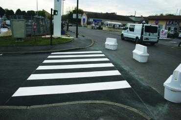 Spray Application of solid thermoplastic traffic crosswalk paint.