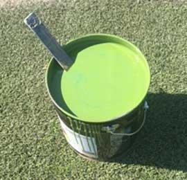 Durable green paint colorant to spray paint synthetic turf fields.