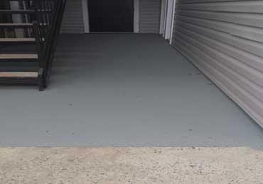 Apartment walkways patios painted with gray anti slip coatings.