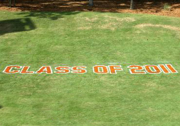 Graduation banners slogans messages painted stencil on grass turf.
