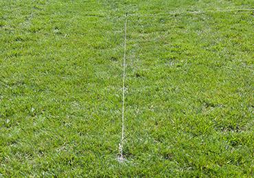 Pull run guide string twine line from football field marker socket to another