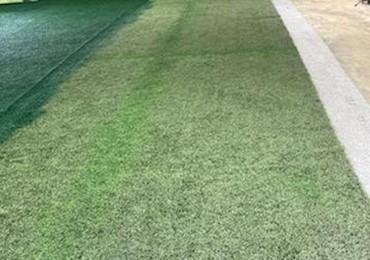 painting old synthetic field turf with painted lines getting covered up and repainted green.