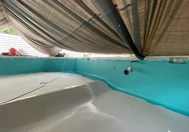 spray application of high performance chlorinated rubber pool paint.