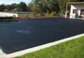 Brand new looking asphalt parking lot after repair with flexible coating.