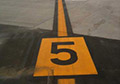 airport runway line marking paint direction arrow numbers striping marking reflective paint.