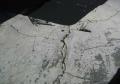 squeegee repair of wide deep cracks asphalt driveway.