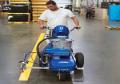 Graco electric battery paint spray line marking indoor warehouse.