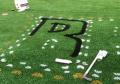 Painting of logo on synthetic field turf using permanent aerosol paint.