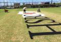 Corporate logo being painted on cricket pitch.