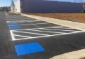 painting of brand new parking lot line marking paint in progress.