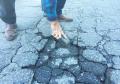 Asphalt pothole repair patch compound cleaning surface preparation.