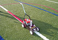 Removable temporary aerosol red spray chalk lacrosse lines synthetic field turf.