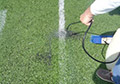 Broom soap water remove chalk temporary removable chalk synthetic field turf.
