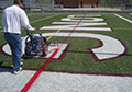 Spraying line marking red removable lacrosse paint lines synthetic field turf.