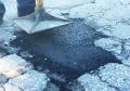 Compact in place asphalt patching material using metal tamper tool.