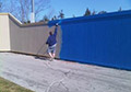 Spray application of exterior wood paint.