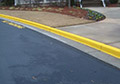 Yellow safety protection street curb paint no parking stencil.