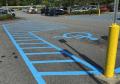 Painting handicap signs with instant dry traffic parking lot paint.