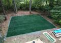 on used re installed synthetic turf grass home back yards old line logo covered up using paint color.