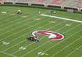 Field painting mid field college logo red bright white paint.