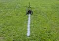 painting straight lines on football field on football fields using guide line string ground sockets.