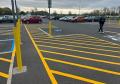 striping lines painting major retail store with traffic parking lot paint.