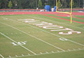 school name letters football field.
