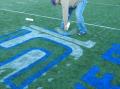 Temporary Chalk for midfield logo on synthetic turf field.