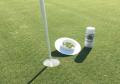 aerosol paint to spray bright visible white on dirt of putting hole.
