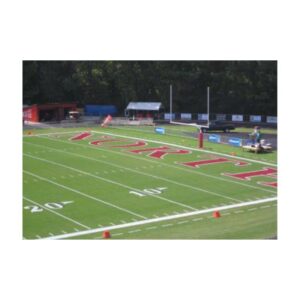 Football end zone painting bright red bright white grass field paint.