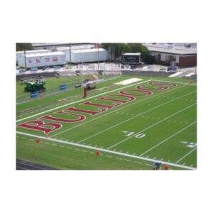 Red color football field end zone marking line striping paint.