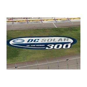 Blue And White Sponsor Logo Stencil Painted On Green Grass