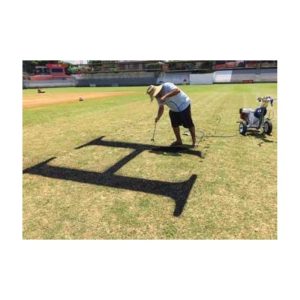 Person Painting A Black Square Stencil Logo On A Sports Field