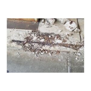 Damaged Concrete Curb With Erosion And Rust Stains