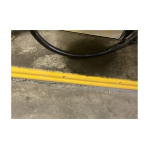 Close-Up Of Curved Yellow Parking Line With Curb Protection Tool