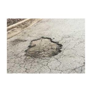 Asphalt pothole pavement damage repair.