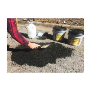 Spread Compact Asphalt Cold Patch Repair Material With Trowel.