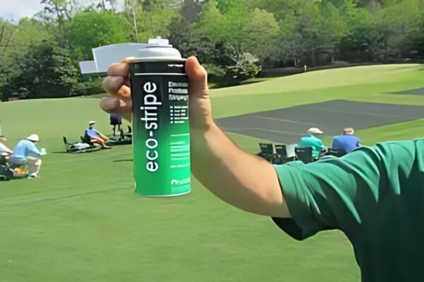 Expert Holding Eco-Stripe Spray Can on Grass